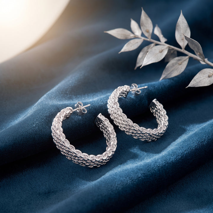 Lyra Woven Hoops in polished silver metal, front view