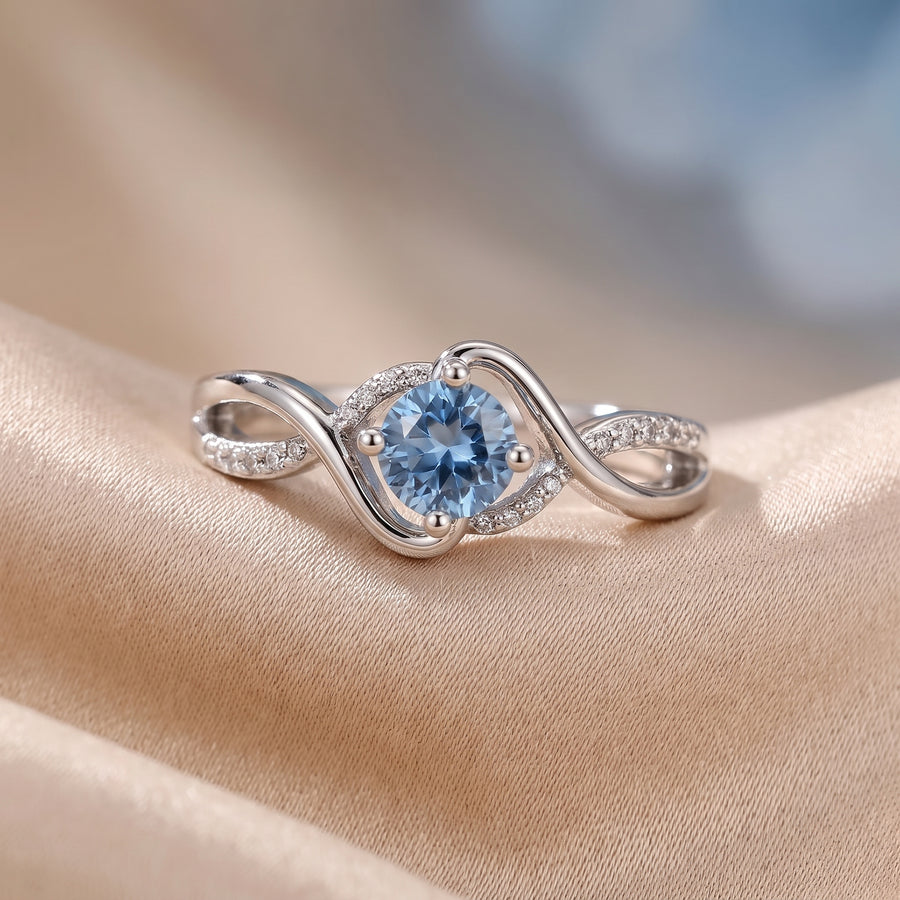 Lunara Wave Infinity Ring with a sky-blue cubic zirconia centerpiece