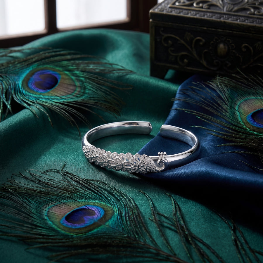 Elysia adjustable sterling silver cuff styled with peacock feathers